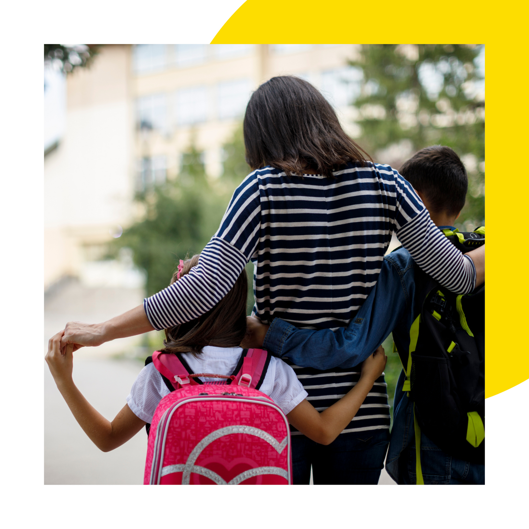 Parent talking to their children on the walk home from school.