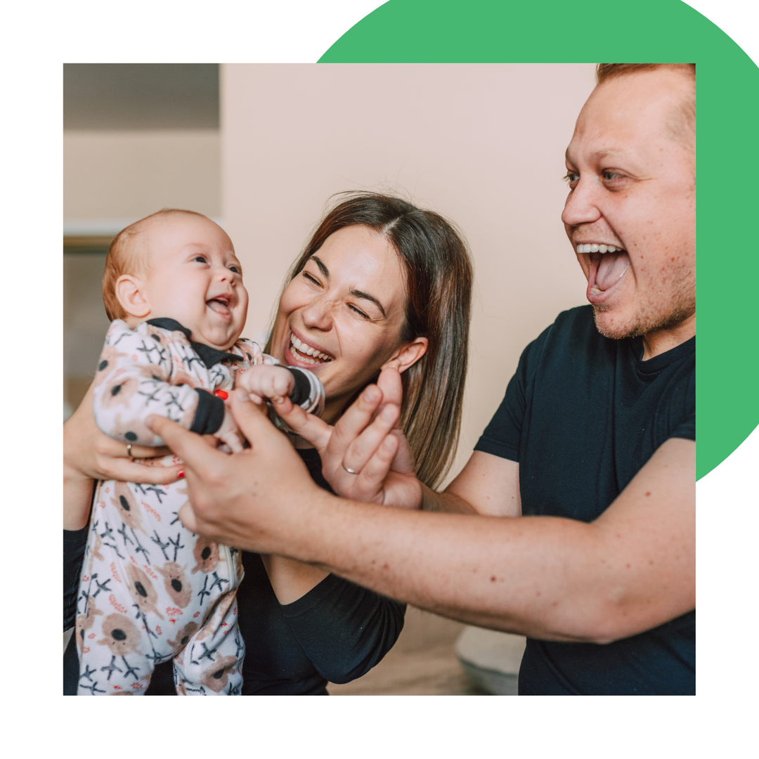Parents making a baby laugh.