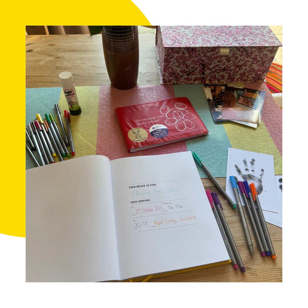 Child's memory journal laid out with red book ready to capture memories of childhood.