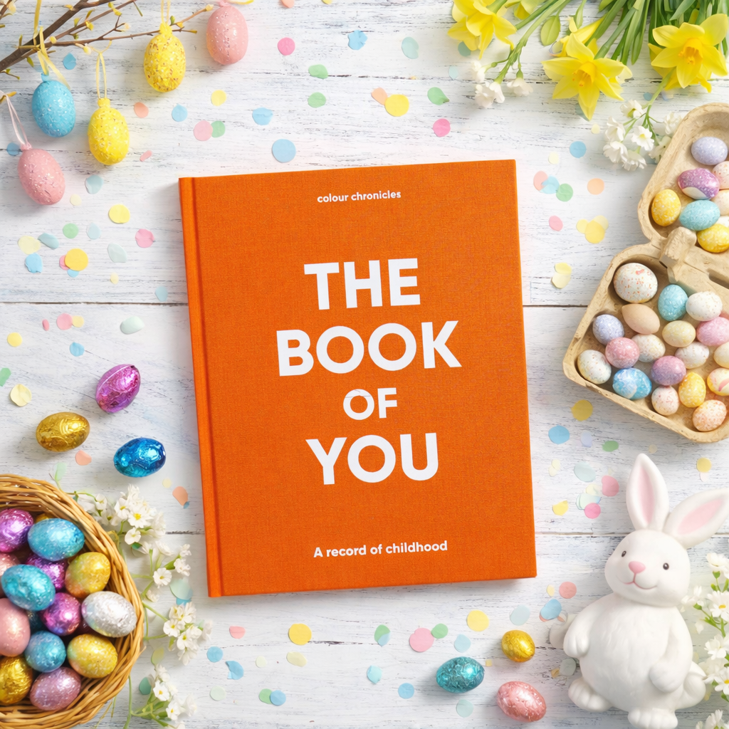 The Book of You childhood memory journal in orange on a table with Easter treats