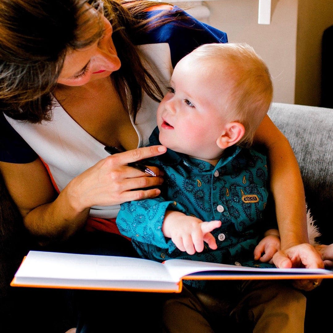 Mother and baby looking at baby record journal together