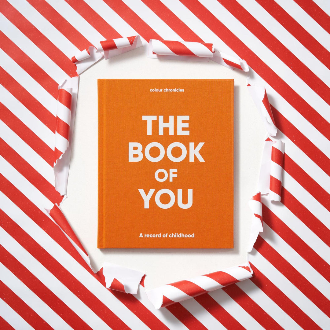 Baby memory book, The Book of You by Colour Chronicles being unwrapped as a gift.